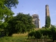 Photo suivante de Pujols L'église romane fin 12ème (MH) et la grande cheminée, seul vestige d'une ancienne briquetterie.