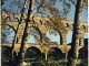 Photo suivante de Remoulins Le pont du Gard - Aqueduc Romain Long 275m, haut 49m, larg 3m - Construit sur l'ordre d'Agrippa, pour amener d'Uzès à Nîmes les eaux des sources d'Eure (carte postale de 1970)