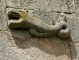 Photo suivante de Chaumeil Porte de la sacristie surmontée d'une sculpture figurant un animal fantastique (animal marin).