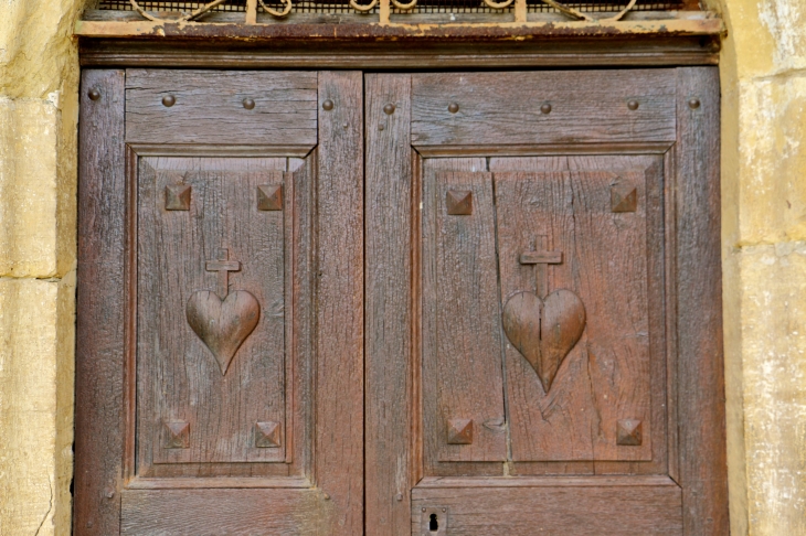 Détail : la porte sculptée de l'église du hameau d'Aunac. - Condom-d'Aubrac