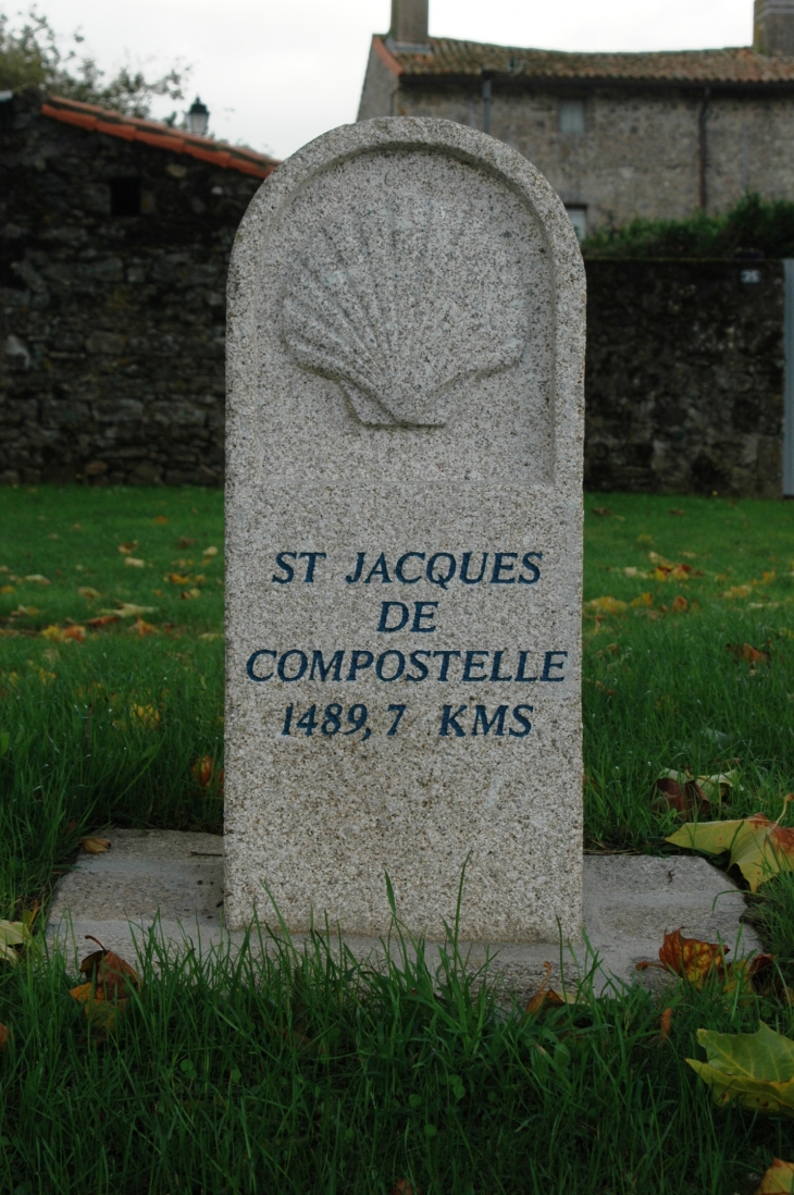 Borne indiquant le chemin de St Jacques de compostelle devant l'église St Pierre  - Parthenay